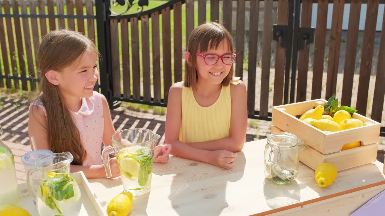 Cheerful Girls Selling Lemonade Outdoors