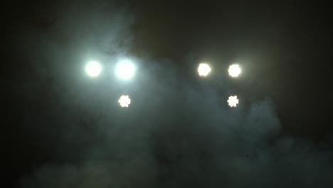 stage lights , floodlights shining brightly and turning on and off