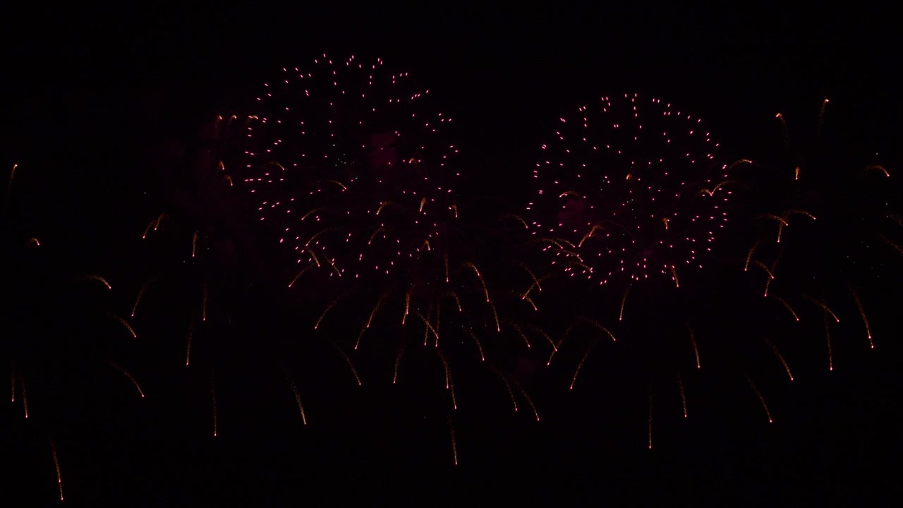Real fireworks on deep black background sky, beautiful colorful fireworks shiny display at night, real time 4k footage.