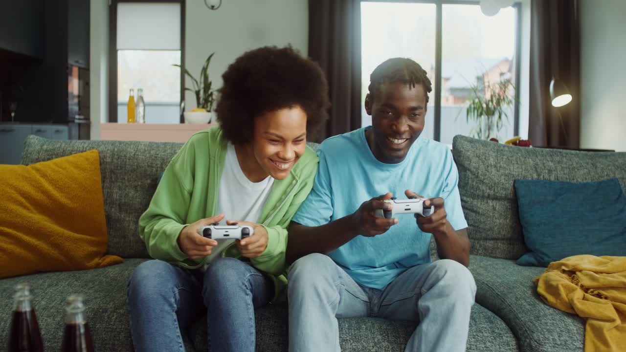 Young people playing video games at home