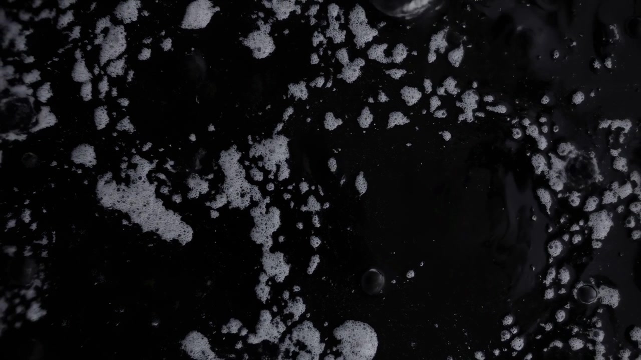 Black Liquid With White Bubbles, Closeup Macro Revealing Floating Foam, Glossy Droplets, Subtle Ripples