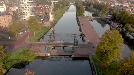 Former-industrial-area-and-transportation-canal-in-the-city-of-Utrecht-now-reformed-into-a-green-neighbourhood-with-floating-houses,-recreational-areas-and-bike-path