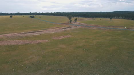 drone aerial rotating over an empty field in australia full of kangaroos