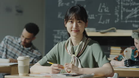young asian woman studying in a classroom