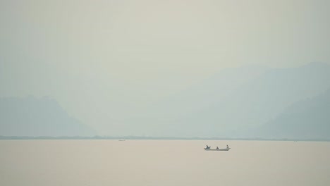 colourful tourist boat trip rowing boats on phewa lake, people on a boat tour in pokhara at sunset in nepal, beautiful fewa lake with amazing dramatic mountain scenery in pokhara