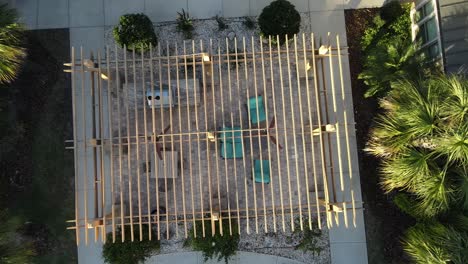 Fast-spinning-view-of-an-arbor-trellis-below-a-golden-hour-drone-clip