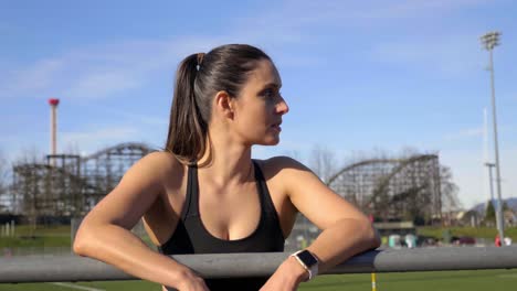 Female-runner-resting-leaning-gainst-railing-after-run