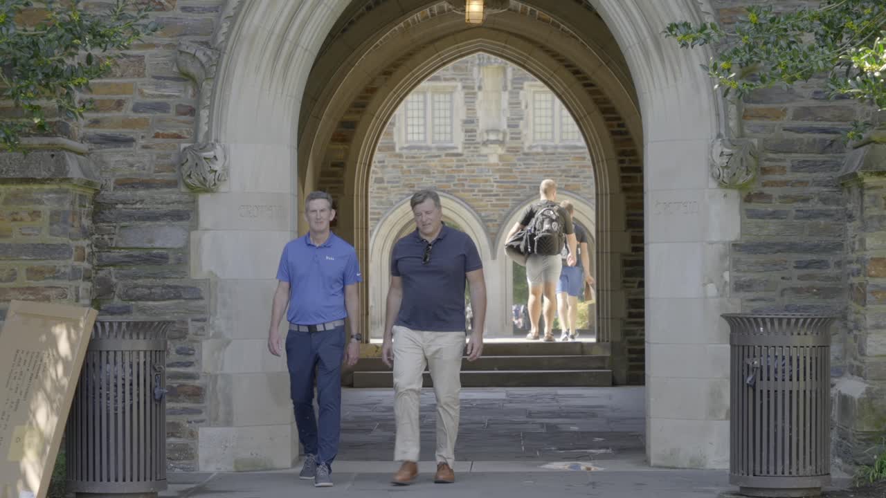 Duke University Students walk across campus on a warm, summer day.