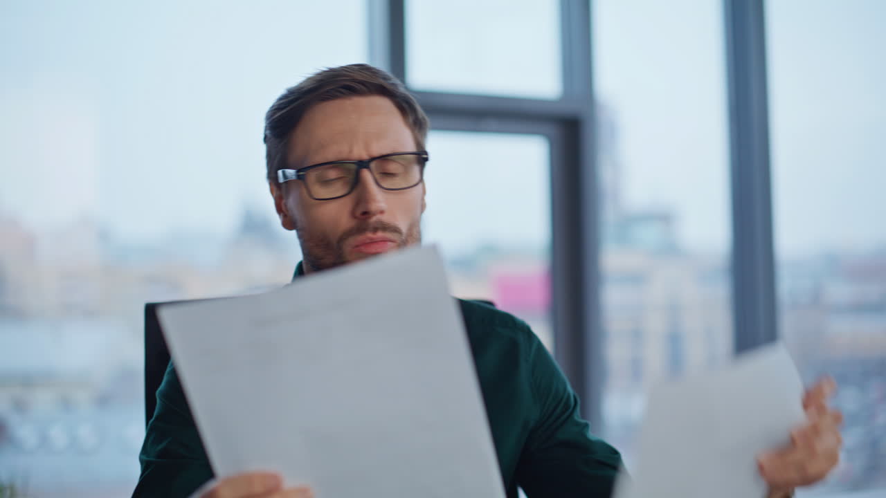 Professional accountant examining papers at workplace closeup. Smiling ceo