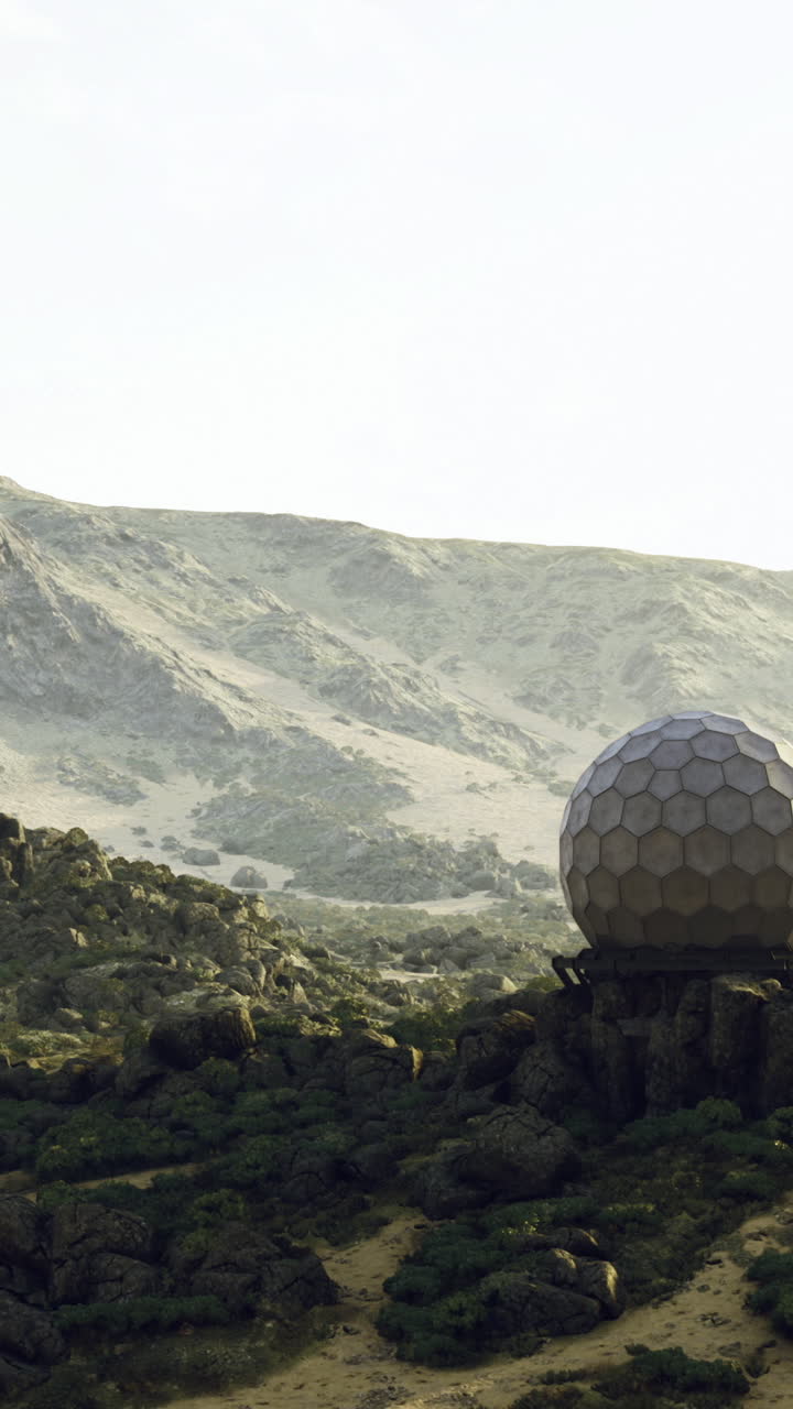 Geodesic dome on rocky landscape during daylight near mountains