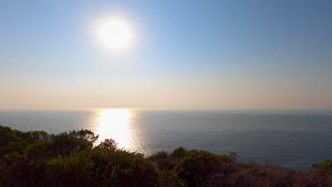 Still-shot-of-the-sun-beginning-to-set-over-the-California-cliffs-in-Half-Moon-Bay---4K