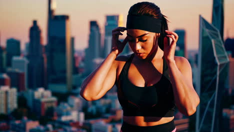 Fit Woman on Rooftop at Sunset in the City