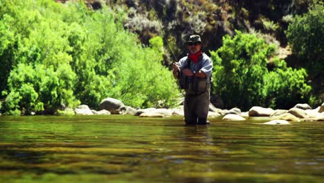 fisherman fly fishing in river