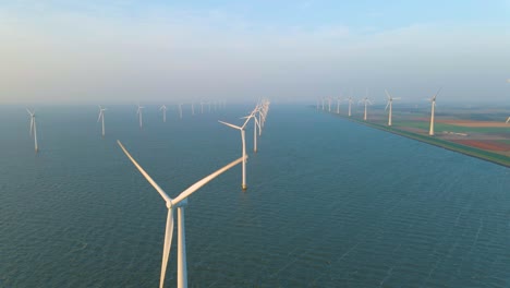 huge windmill turbines, offshore windmill farm in the ocean westermeerwind park , windmills isolated at sea on a beautiful bright day netherlands flevoland noordoostpolder