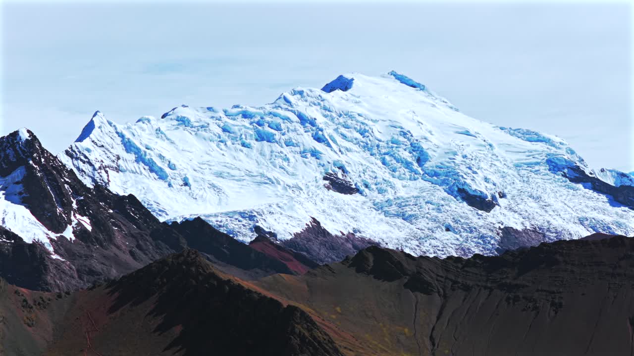 Peruvian Andes Ausangate Glacier Rainbow Mountain Vinicunca Peru Perú glacial Nevado Auzangate Vilcanota Cusco Region morning blue sky clouds Hatun Ritty rainy season forward parallax motion