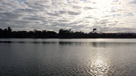 Calm-river-with-the-summer-or-winter-morning-sun-reflects-on-the-water,-sky-with-beautiful-nature-and-clouds-sunrise-in-Sydney,-Australia