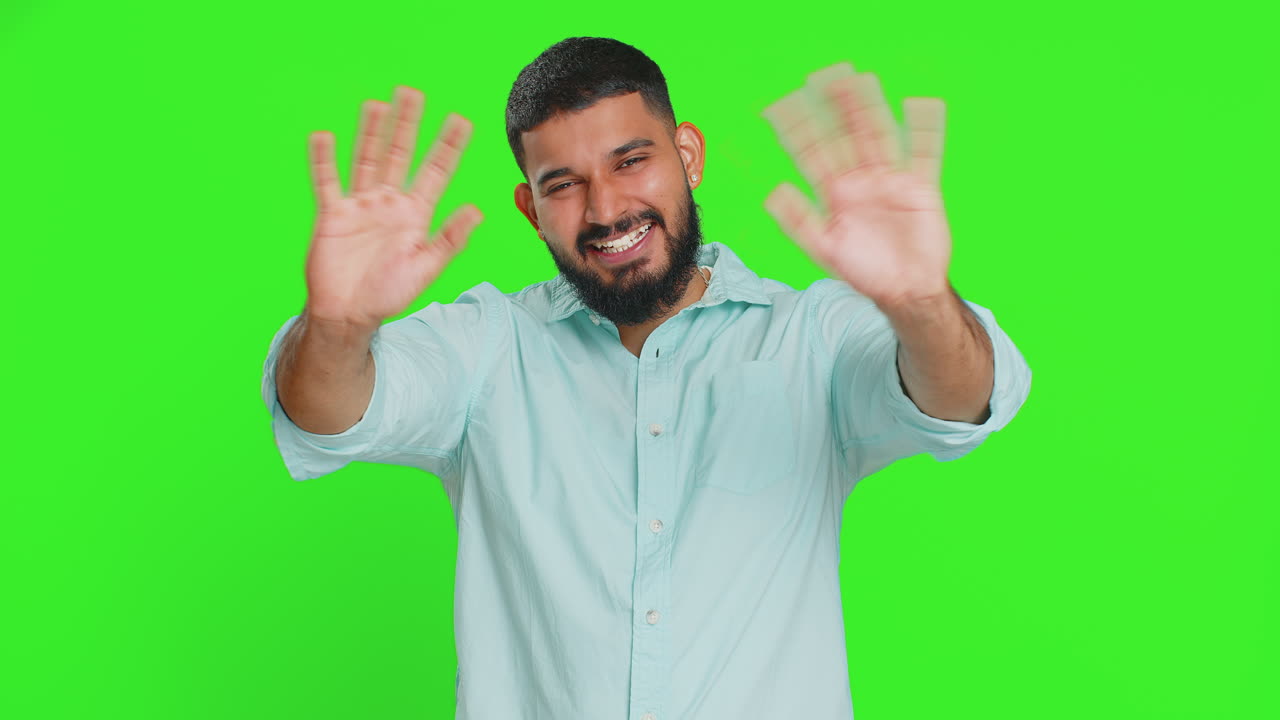 Happy man smiling friendly waving hands gesturing hello greeting or goodbye meeting invitation