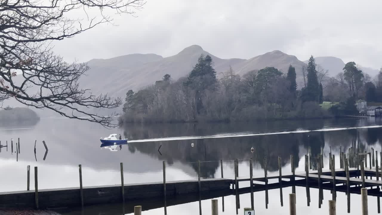 Boat passing on Derwentwater with Derwent Island and Catbells in the background - Keswick, Lake District