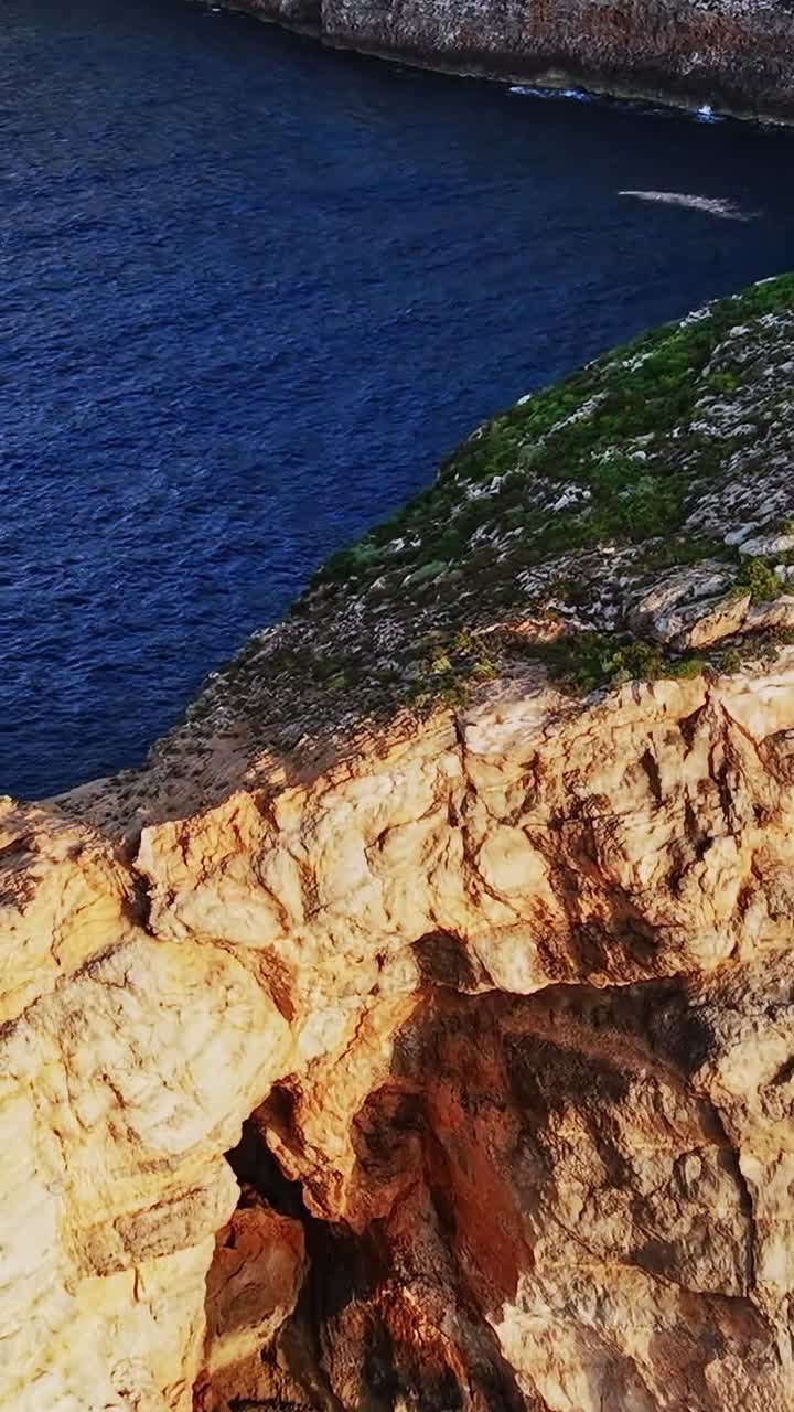 Exploring the rocky coastline of Malta with clear blue waters