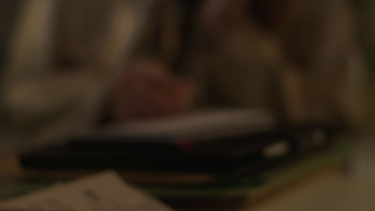 Person Writing in a Notebook