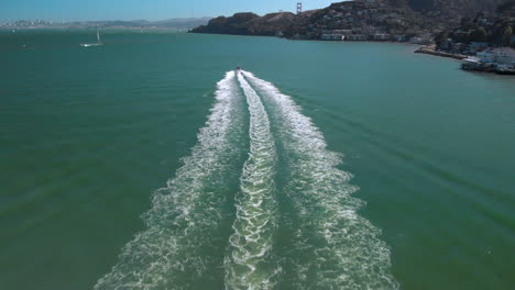 following a boat departing sausalito harbor toward the golden gate bridge