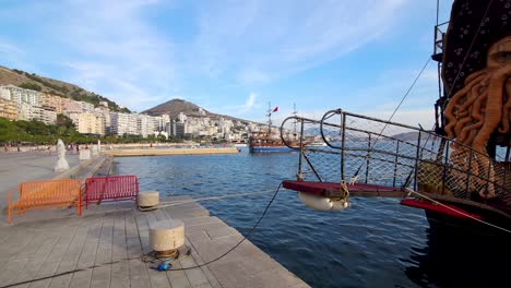 pirate adventure tour ship with swashbuckling charm anchored on the pier in saranda bay, infusing coastal city magic