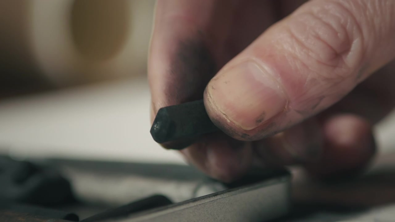 Extreme close-up of smudged fingers after drawing, symbolizing effort, immersion, and the physical connection to traditional art techniques.
