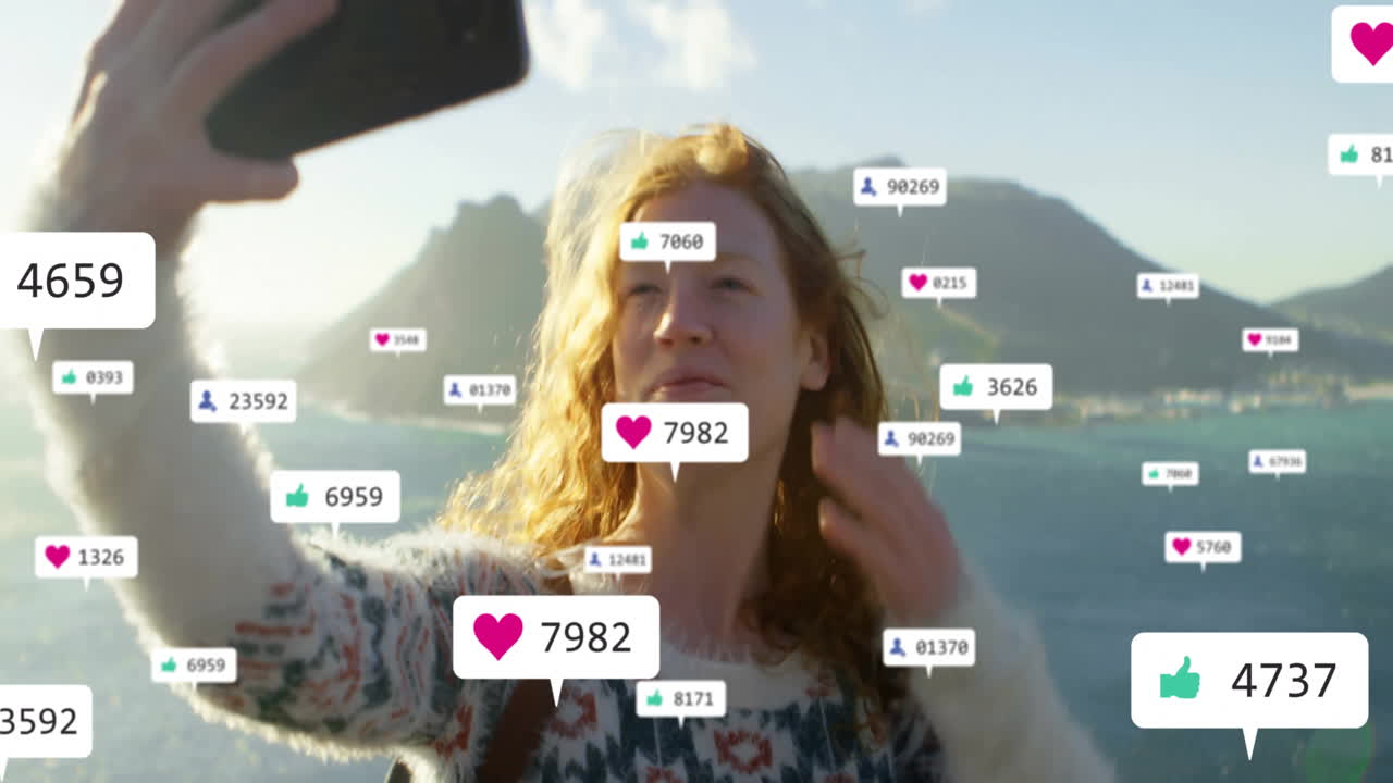 Taking selfie, woman with animation of social media likes and comments