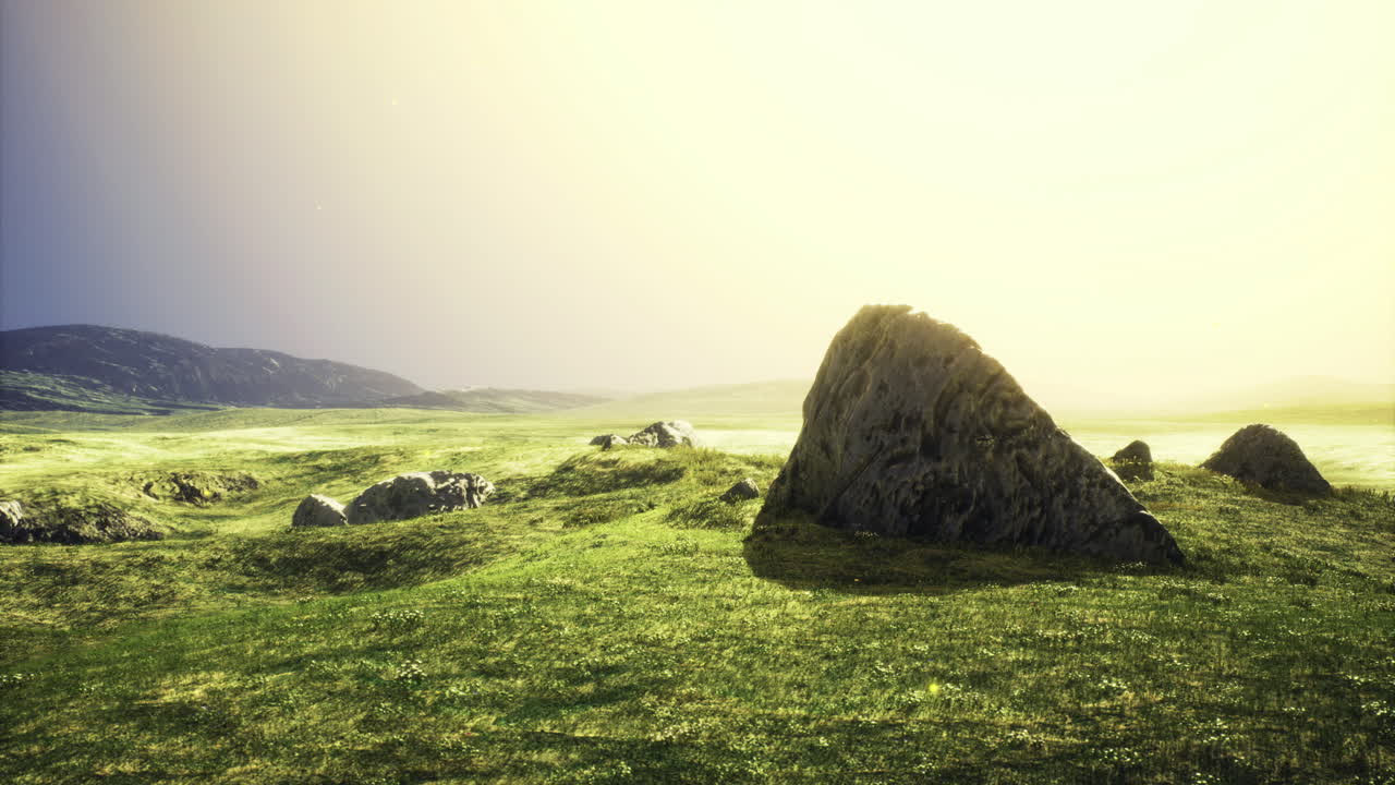 Sunlight dances over rocky terrain in a serene landscape at dawn