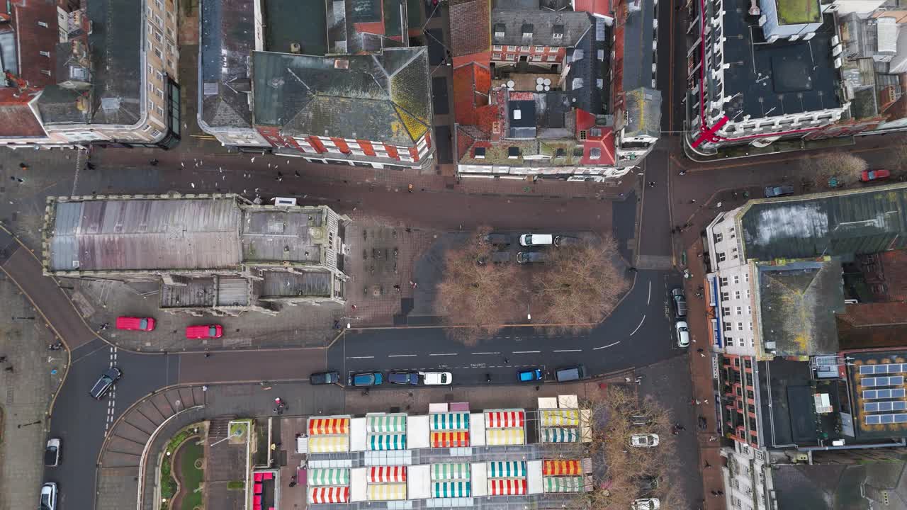 An aerial view of Norwich's historic buildings, market stalls, and urban streetscape