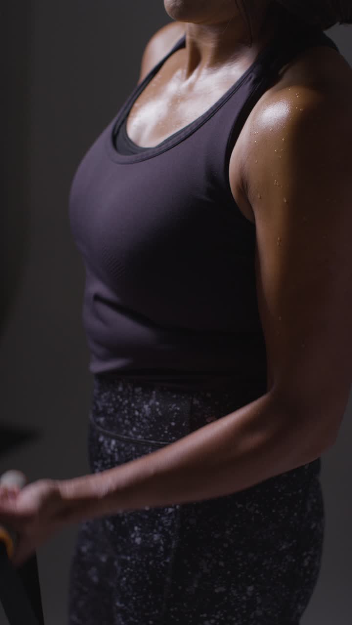Vertical Video Close Up Shot Of Mature Woman Wearing Gym Fitness Clothing Exercising With Resistance Band