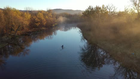 kayaker on a misty morning river