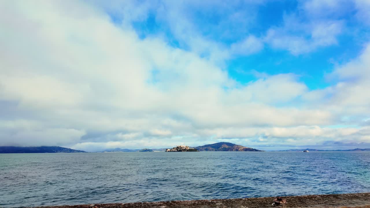 Walking on Pier 41 wooden Bay Walk towards the sea with Alcatraz in the background