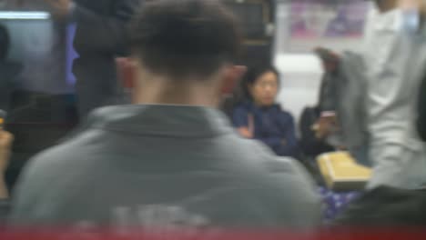 commuters sat on train in seoul