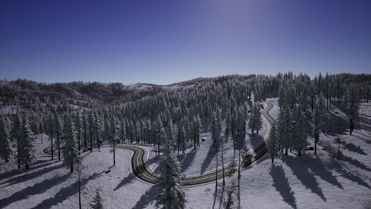 Winding road through snow covered forest on a clear winter day