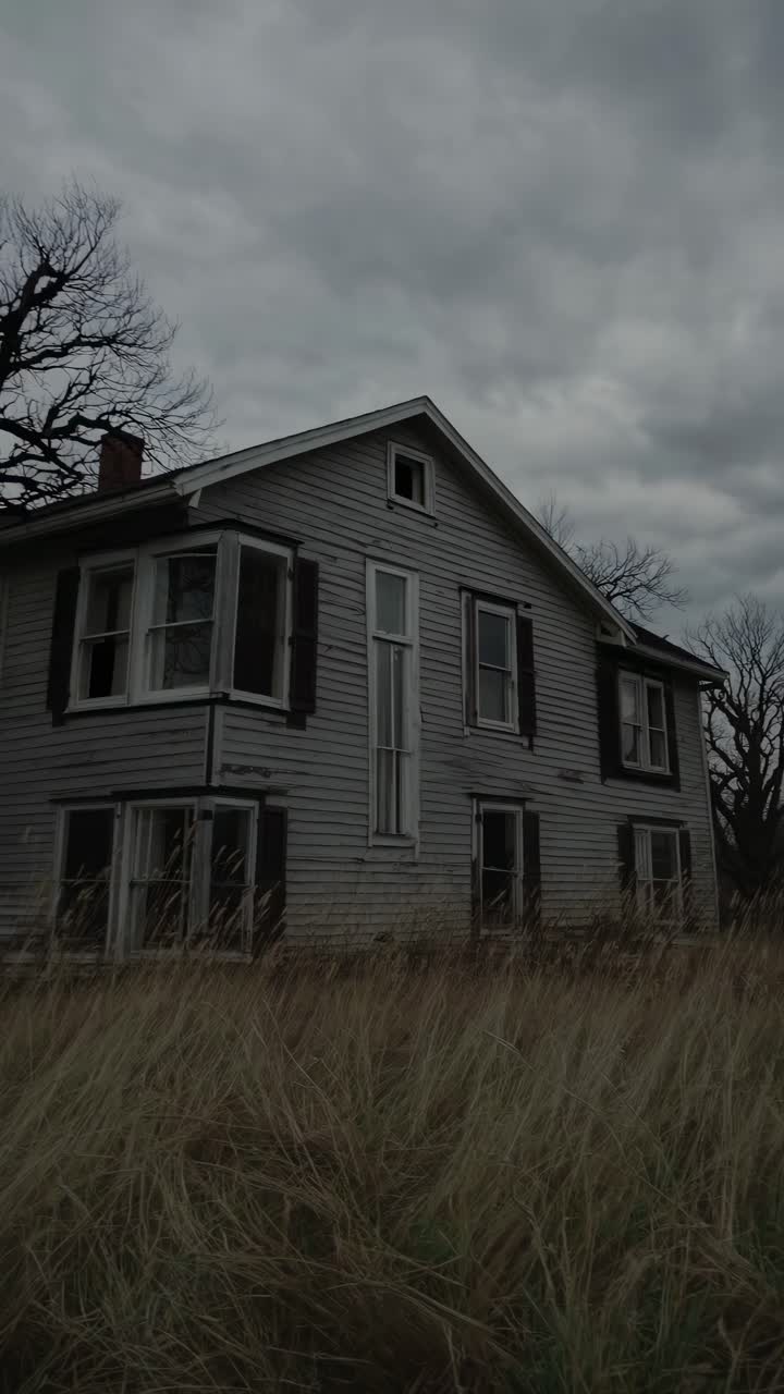 Eerie video still of an abandoned house under a cloudy sky, captured from a low angle