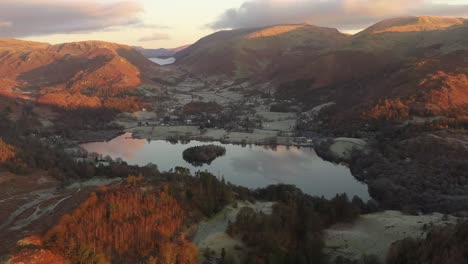 an aerial view over grasmere in the lake district at sunrise