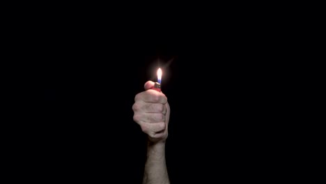 hand holding a lighter with a flame