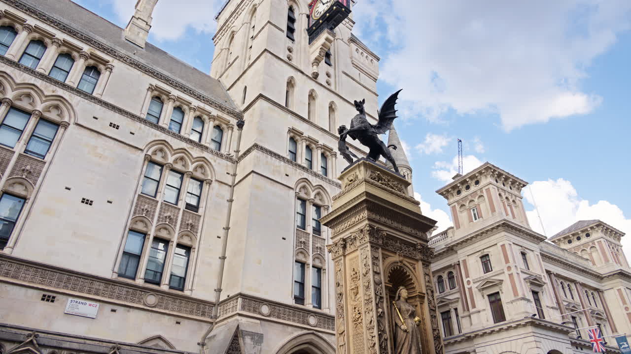 Close up of the Temple Bar dragon statue and intricate Gothic architecture of the Royal Courts of Justice, London, England