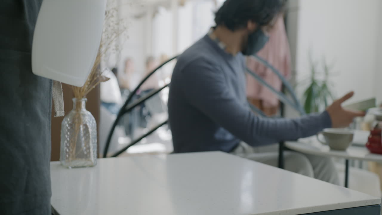 Cafe Staff Sanitizing Tables