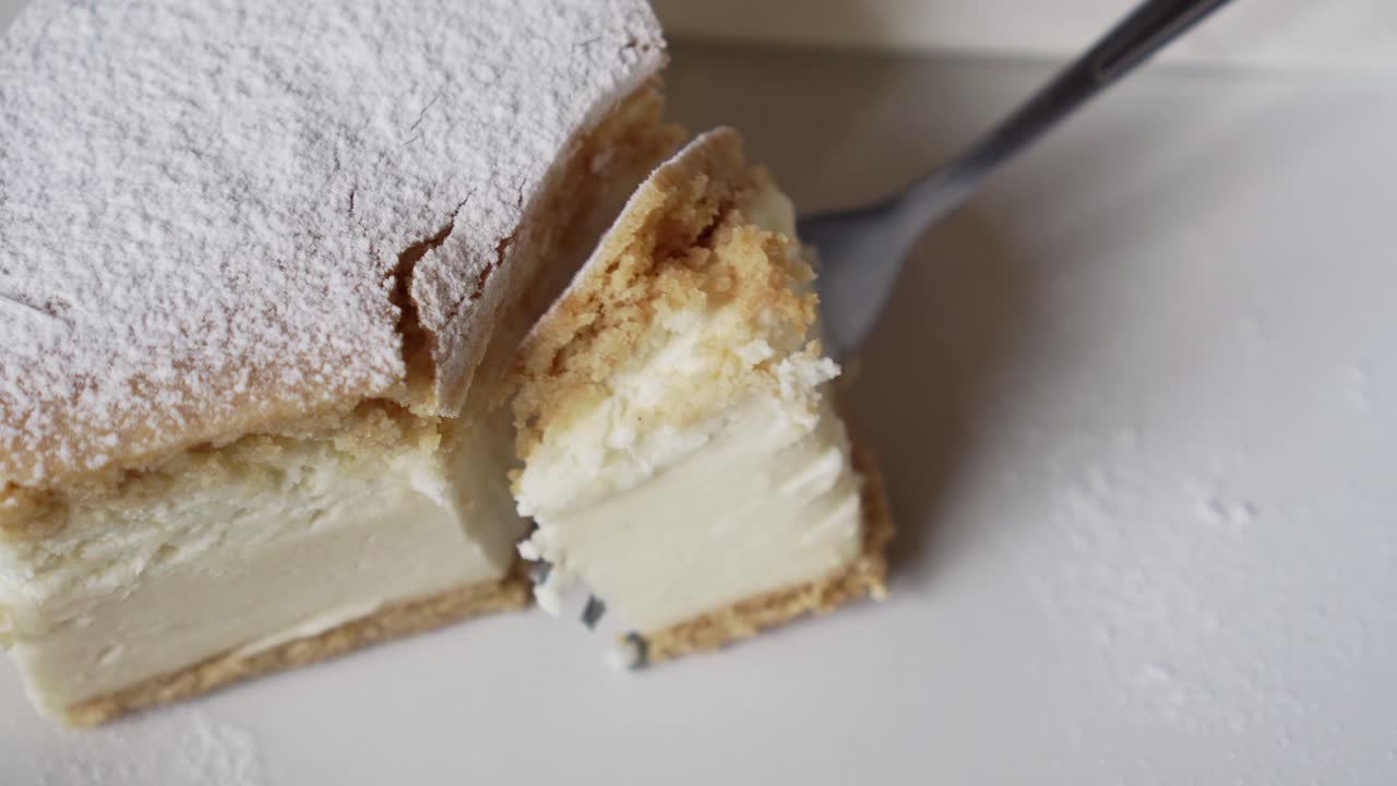 Cutting out a piece of cake with a fork, shot from above