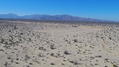 View-of-a-drone-panning-left-from-a-manifestation-in-the-middle-of-a-highway-to-the-mountains