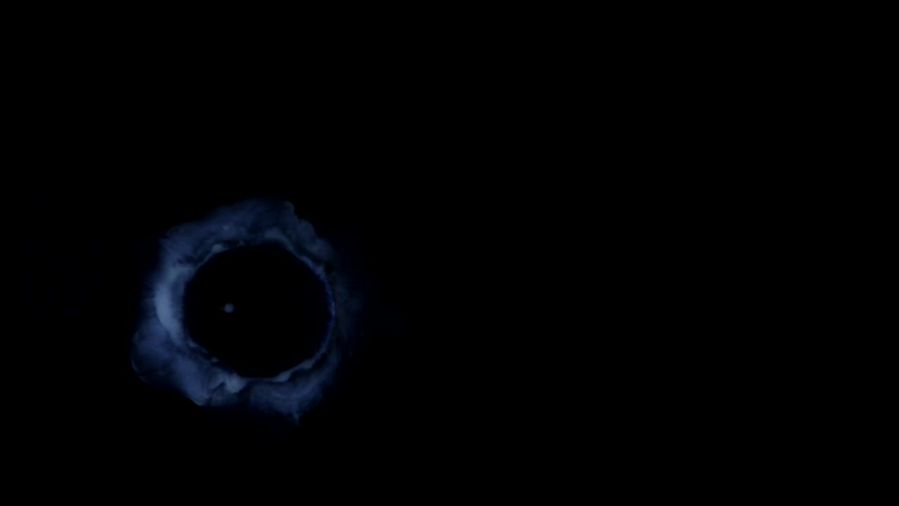 A dark orb in a dark background pulses with subtle energy