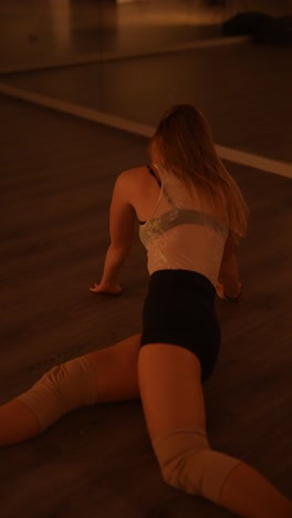 female dancer stretching and practicing in a dance studio