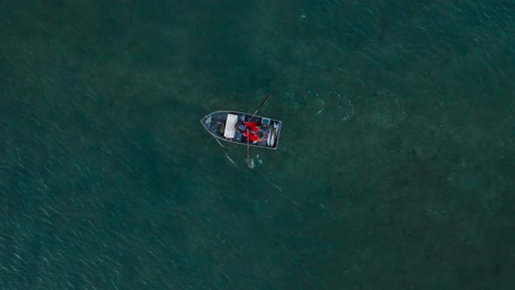 birdseye view of fishermen rowing boat against outgoing tide