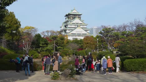 tourists at osaka castle park in autumn