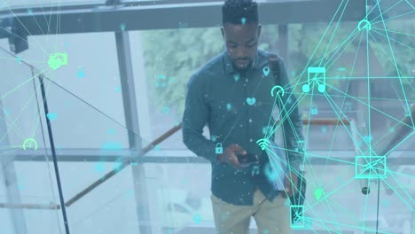 animation of media icons over african american businessman using smartphone