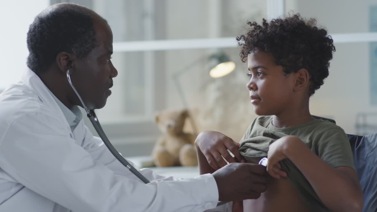 A doctor examining a young boy with a stethoscope