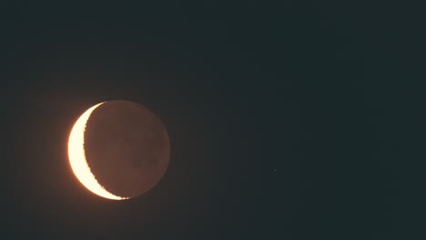 the shaded moon in the clear night sky