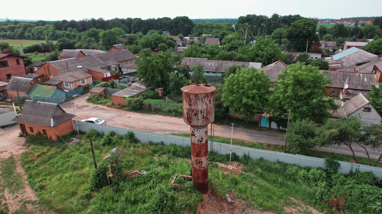 Old water tower in summer aerial shot. 4k stock footage.